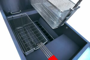 Deep fryer with wire baskets inside.